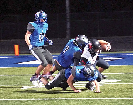 South Callaway defensive back Chrisjen Davis (7) and defensive back Holden Adams (20) combine to take down a Clopton/Elsberry ball carrier as linebacker Hayden Vaught looks on during the Bulldogs' 54-20 rout of the IndianHawks last week in Mokane.