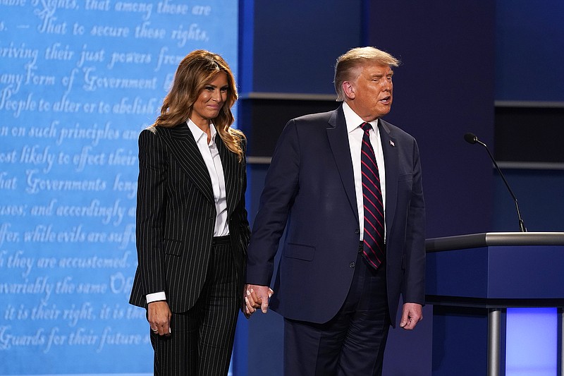 President Donald Trump stands on stage Tuesday with first lady Melania Trump after the first presidential debate with Democratic presidential candidate former Vice President Joe Biden at Case Western University and Cleveland Clinic in Cleveland, Ohio