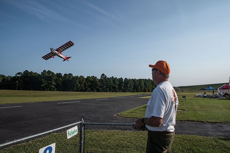Patrick Mason flies his Decathlon remote control plane at the Texarkana Radio Control Flying Club Annual Fly-In at Wright Patman Lake on Friday evening. The plane is a replica at 40% of the size of a fully operational Decathlon plane.
