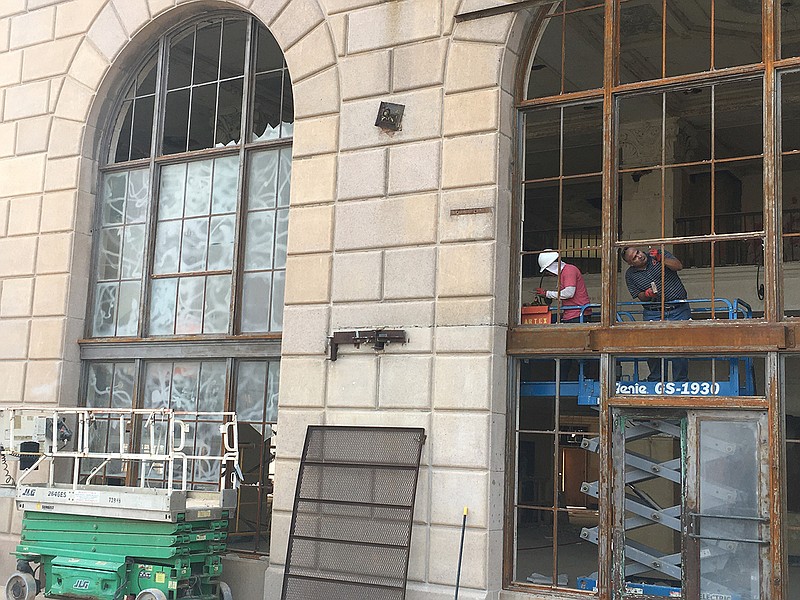 Workers renovate the entrance to the Grim Hotel.