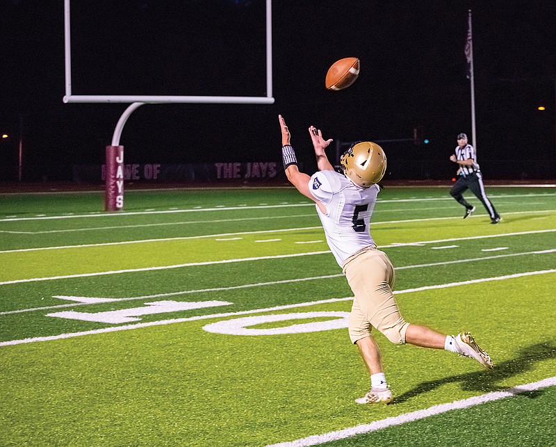 Helias senior Alex Clement stretches out to make a catch in the first half of Friday's game against Capital City at Adkins Stadium.