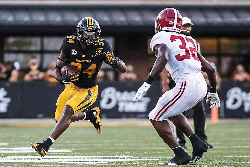Missouri running back Larry Rountree III carries the ball as Alabama linebacker Dylan Moses looks to make the tackle during last Saturday's game at Faurot Field.