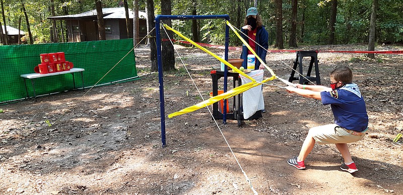 Bill Newton (9) Webelo of Pack 8, takes aim with the two-handed slingshot, one of the range activities at Camp Preston Hunt. He was enthusiastic about the activities of Fun Day and anticipated the pedal cars and hiking activities that were coming up.
