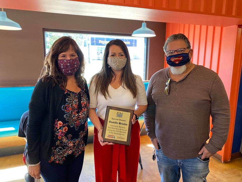 From left: Lisa Lindsey, Camille Wrinkle and Mario Garcia pose for a photo as Wrinkle is presented with the Unsung Hero plaque. (Submitted photo)
