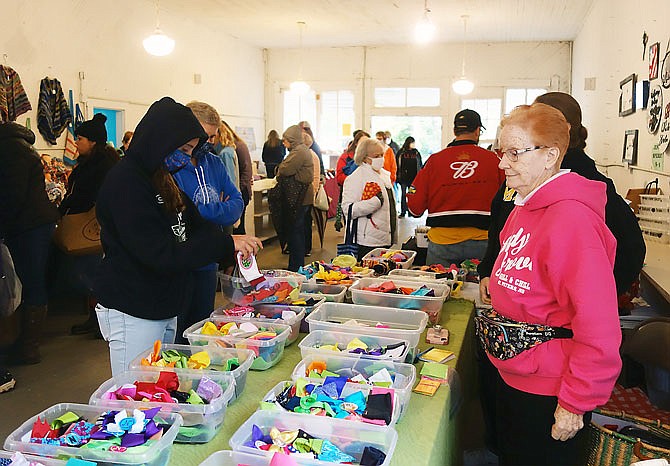 Kathleen Keane, right, set up her hair-bow booth in her usual spot Saturday. "Keane's Krafts" returns to the Hatton Arts & Crafts Festival each year, she said.