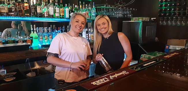 Kasey Fant, left, and Autum Bohanon get the bar ready for the evening crowd at the 1873 Club of Texarkana, located downtown at the site of the former Paragon.