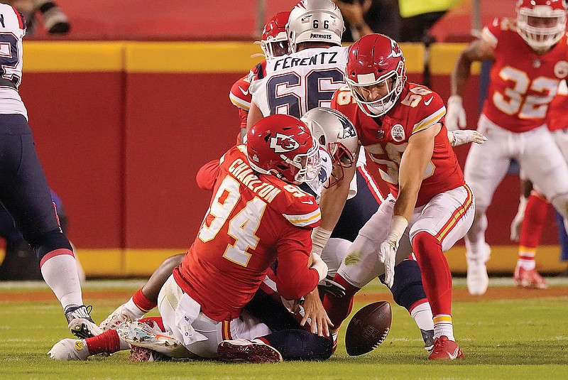 Patriots quarterback Brian Hoyer fumbles as he is tackled by Chiefs defensive end Taco Charlton and linebacker Ben Niemann during the second half of Monday night's game at Arrowhead Stadium. Niemann recovered the fumble.
