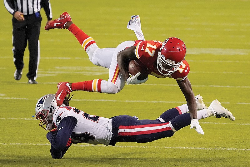Chiefs wide receiver Mecole Hardman is tackled by Patriots cornerback Stephon Gilmore after catching a pass during the second half of Monday night's game at Arrowhead Stadium.