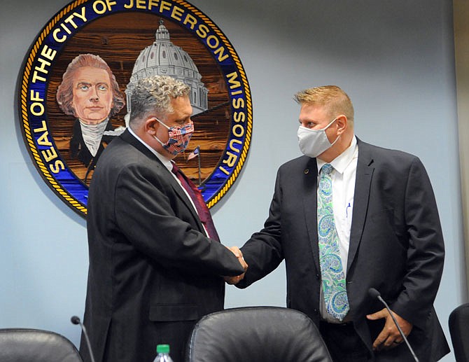 Candidates for Cole County associate circuit judge, Republican Brian Stumpe, left, and Democrat Scott Evans, greet each other Tuesday at the beginning of a forum at Jefferson City Hall. 