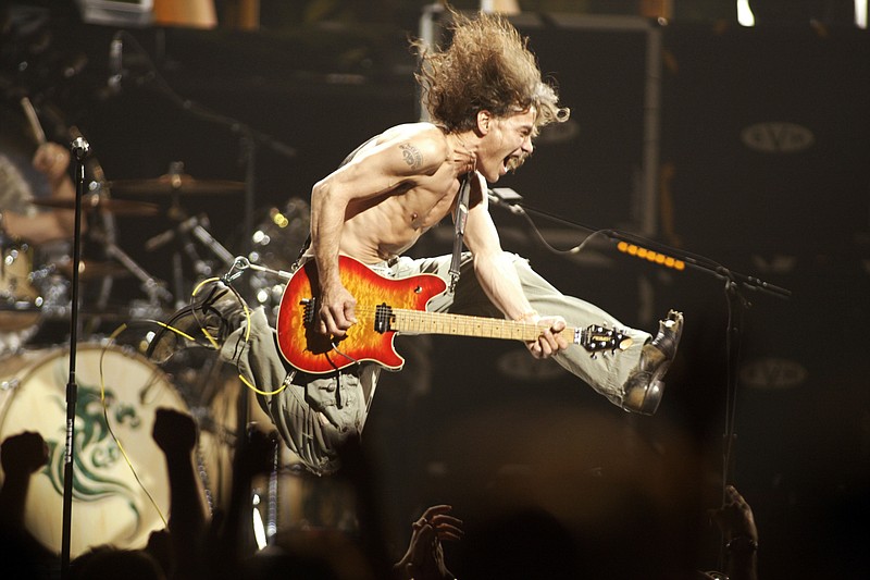 FILE - In this June 22, 2004, file photo, Eddie Van Halen plays the final chord of "Jump" during the Van Halen concert at the Continental Airlines Arena in East Rutherford, N,.J. Eddie Van Halen, the guitar virtuoso whose blinding speed, control and innovation propelled his band Van Halen into one of hard rock’s biggest groups, died Tuesday, Oct. 6, 2020.  Van Halen, who had battled cancer, was 65. (John Munson/NJ Advance Media via AP)