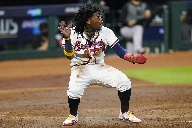 Atlanta Braves' Ronald Acuna Jr. scores on a double by Marcell