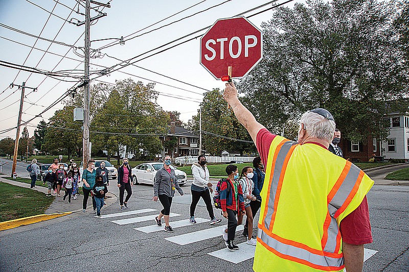 Allen Herman serves as crossing guard Wednesday morning, Oct. 7, 2020, to ensure teachers and students from Moreau Heights Elementary School were able to safely cross the street at Leslie Boulevard. 