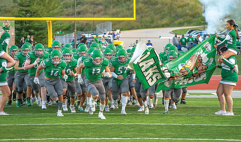 Blair Oaks players run onto the field before the start of last month's game against Boonville at the Falcon Athletic Complex in Wardsville.