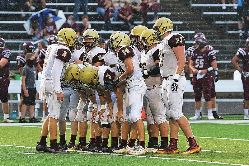 Eldon quarterback Hunter Hees (far left) reports a play to the rest of the Mustang offense during a game against School of the Osage earlier this season at Osage Beach.