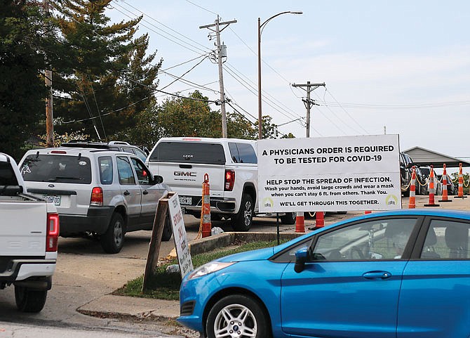 People line up in their cars Thursday for COVID-19 testing outside of the Capital Region Physicians — Family Care building. There were three lanes full of cars waiting for testing that afternoon.