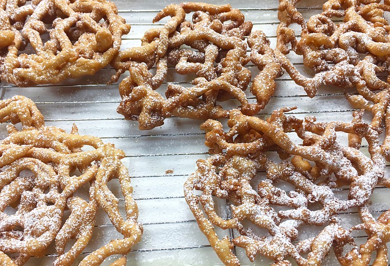 Homemade Funnel Cakes dusted with confectioners' sugar (Arkansas Democrat-Gazette/Kelly Brant) 9/30/2020