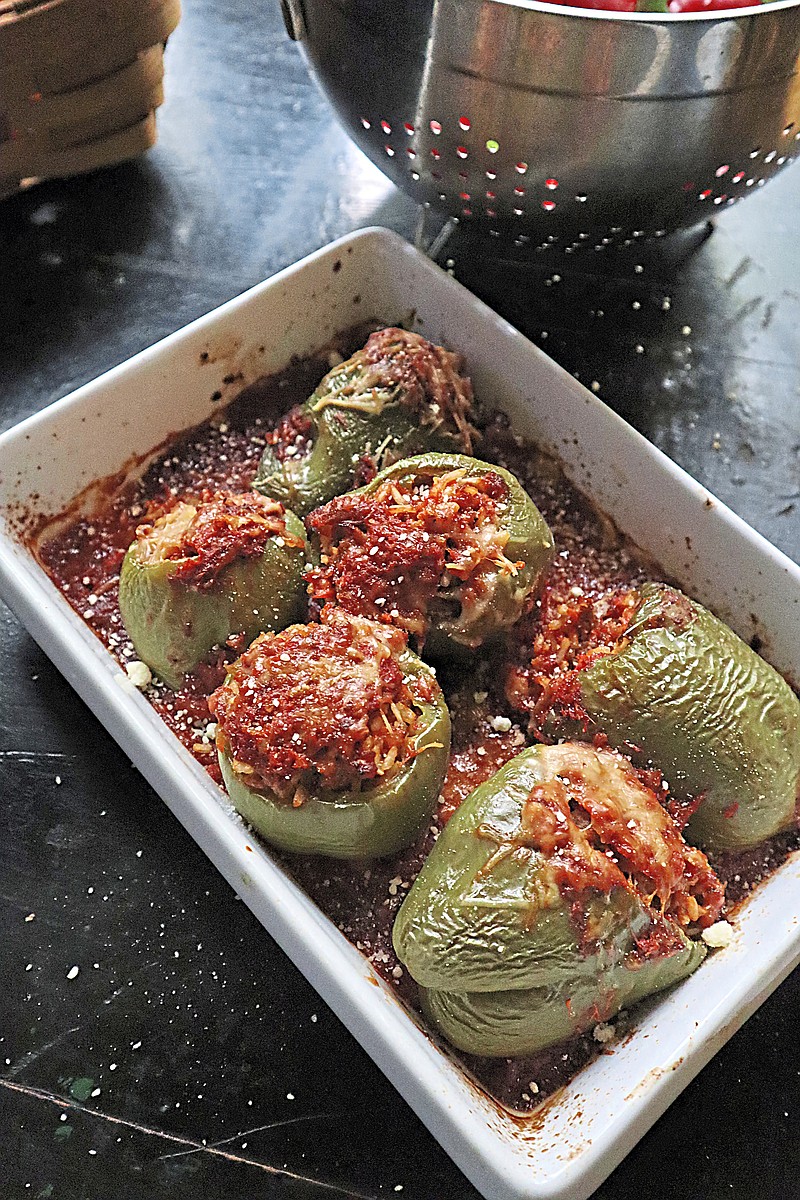 Bell peppers stuffed with a cheesy mixture of sweet Italian sausage, brown rice and Parmesan cheese make a hearty fall meal. (Gretchen McKay/Pittsburgh Post-Gazette/TNS)