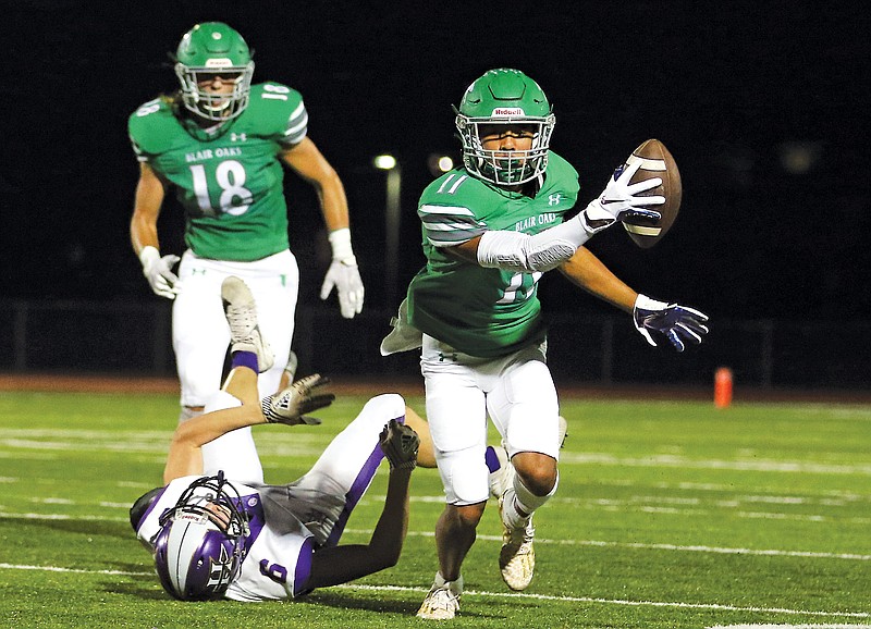 Blair Oak cornerback Cobi Marble starts running with the ball after intercepting a pass intended for Hallsville wide receiver Jalen George during Friday's Homecoming game at the Falcon Athletic Complex in Wardsville. Marble returned the interception 31 yards for a touchdown.