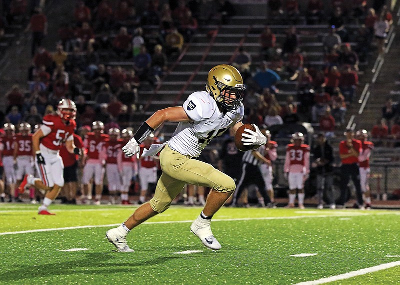 Helias receiver Cole Stumpe breaks free for a 37-yard touchdown catch on a pass from Jake Weaver during Friday night's game against Jefferson City at Adkins Stadium. It was the first score in a football game between Helias and Jefferson City.