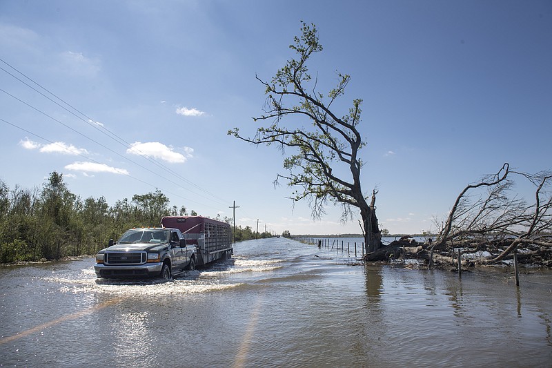 Floodwater covers a road just southeast of Lake Charles, La., following Hurricane Delta on Saturday, Oct. 10, 2020. (Chris Granger/The Advocate via AP) 