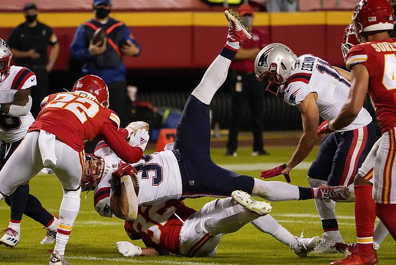 Patriots running back Rex Burkhead is tackled by Chiefs teammates Tyrann Mathieu (bottom) and Juan Thornhill during the second half of last Monday's game at Arrowhead Stadium.