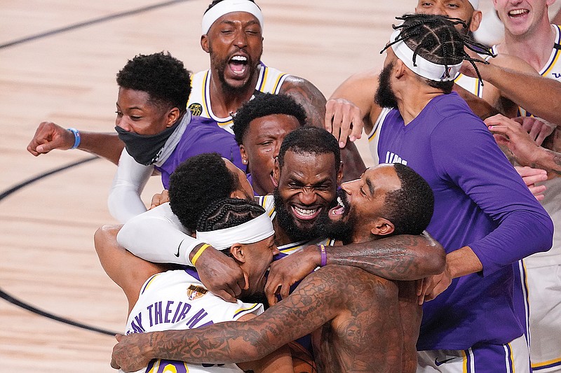 LeBron James celebrates with his Lakers teammates after Sunday night's victory against the Heat to win the NBA Finals in Lake Buena Vista, Fla.