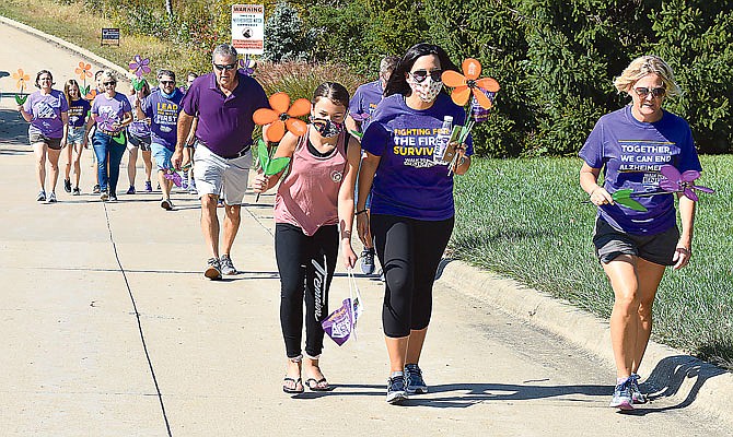 Members of Team Roehl and Friends walk in a neighborhood off Constitution Drive during Sunday's Walk to End Alzheimer's.