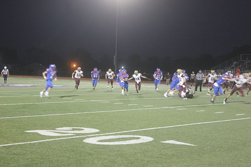 <p>Democrat photo/Kevin Labotka</p><p>Calen Kruger gets some blocking help Oct. 9 as he runs for the first of his three rushing touchdowns in the Pintos’ win over Eldon.</p>