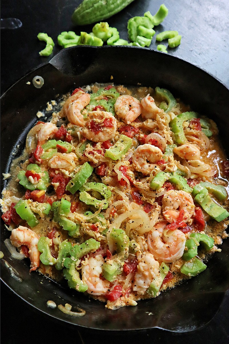 The Filipino stew ginisang ampalaya is made with bitter melon, tomatoes, eggs and shrimp. Nutritious and budget-friendly, it is both savory and slightly bitter. (Gretchen McKay/Pittsburgh Post-Gazette/TNS)