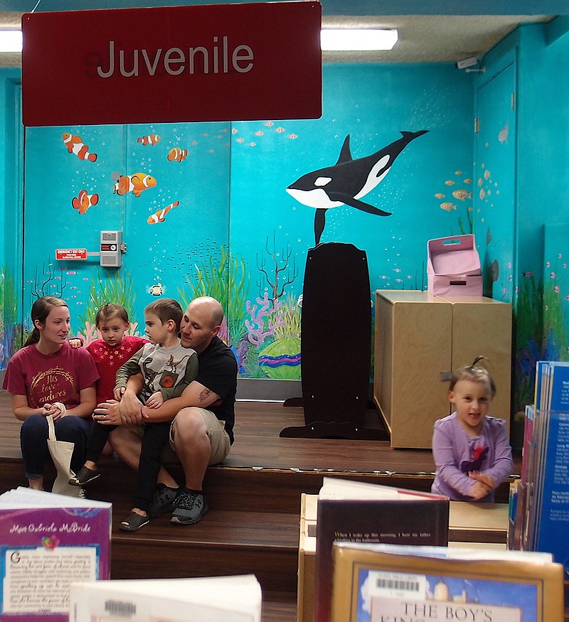 The Trevor McMillon family can be like a family of fishes in the underwater world of the children's section in the Atlanta library. There's plenty to read and look at here. 
