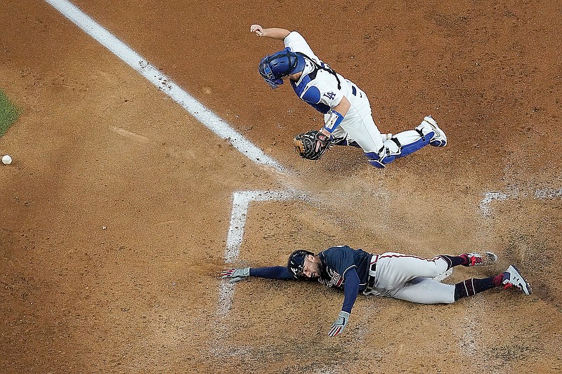 Nick Markakis of the Braves scores past Dodgers catcher Will Smith on a double by Cristian Pache during the fifth inning Tuesday in Game 2 of the National League Championship Series in Arlington, Texas.