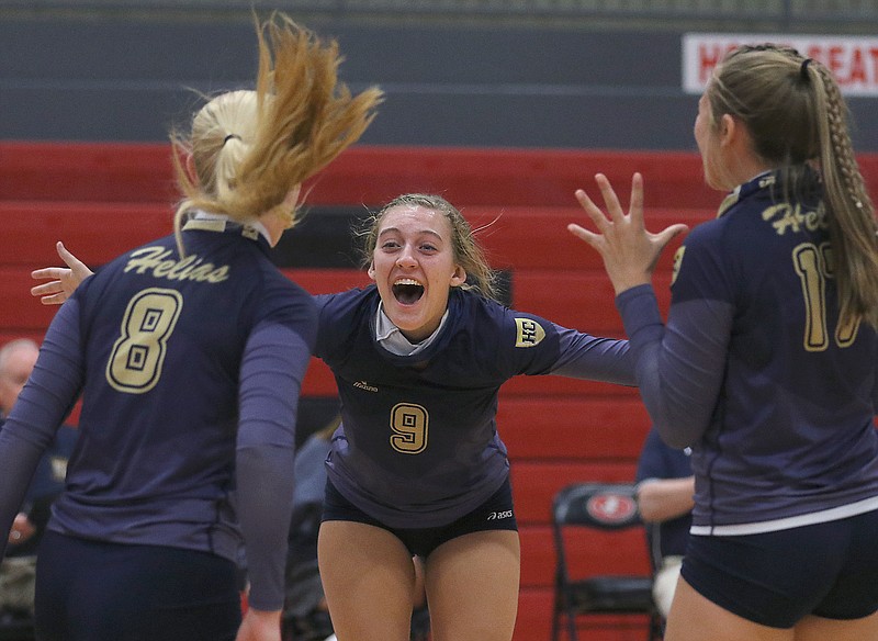 Helias setter Grace Verslues yells in celebration with her teammates after the Lady Crusaders scored the final point in Tuesday night's win against the Jefferson City Lady Jays at Fleming Fieldhouse.