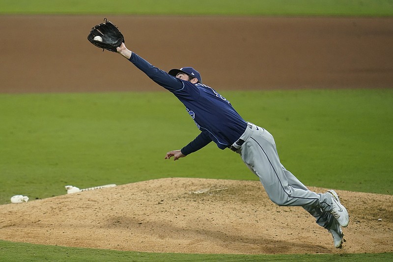 Rays pitcher John Curtiss snares a ball hit by Yuli Gurriel of the Astros during the seventh inning of Tuesday night's Game 3 of the American League Championship Series in San Diego.