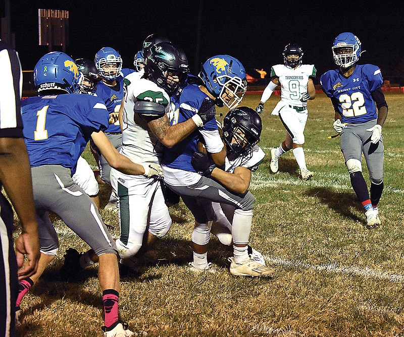 Two North Callaway defenders combine to stop a Wright City ball carrier during last week's game at Wright City.