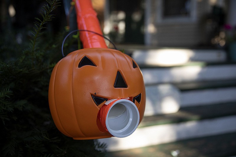 A jack-o-lantern adorns the end of a candy chute for trick-or-treaters made by Liam Ford, a Chicago Tribune editor, on Oct. 8, 2020, in Chicago. The treat tube delivers Halloween candy without contact. (Erin Hooley/Chicago Tribune/TNS)
