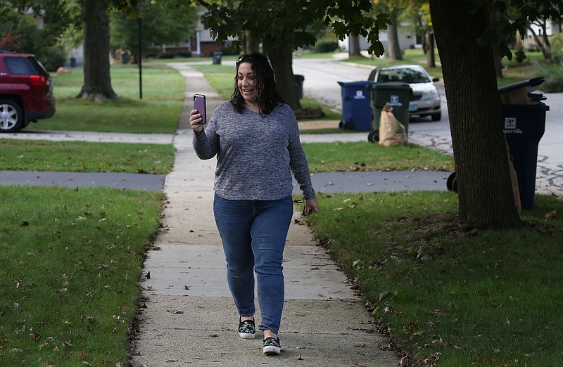 Nicole McCabe makes a video of herself to send out to her close but long distance friend Erin Baird of Ft. Mill South Carolina using the video app Marco Polo while walking in her Naperville neighborhood, Tuesday, Sept. 29, 2020.   (Antonio Perez/ Chicago Tribune/TNS)