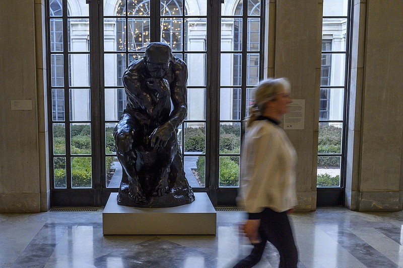 A woman walks by "The Thinker" sculpture by Auguste Rodin at the Baltimore Museum of Art on Jan. 15, 2020 in Baltimore, Maryland.  (Eric Baradat/AFP/Getty Images/TNS) 