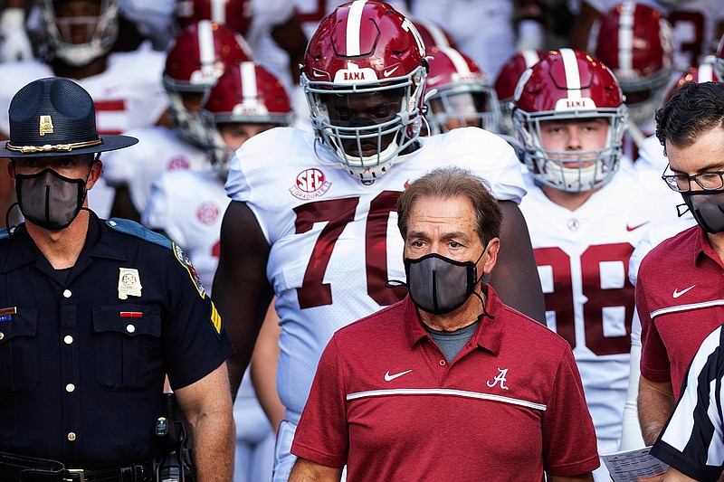 In this Sept. 26, 2020, file photo, Alabama coach Nick Saban leads his team to the field before an NCAA college football game against Missouri in Columbia, Mo. Saban and athletic director Greg Byrne have tested positive for COVID-19, four days before the Southeastern Conference's biggest regular-season showdown.  The second-ranked Crimson Tide is set to face No. 3 Georgia on Saturday, and may be without their iconic 68-year-old coach. (AP Photo/L.G. Patterson, File)