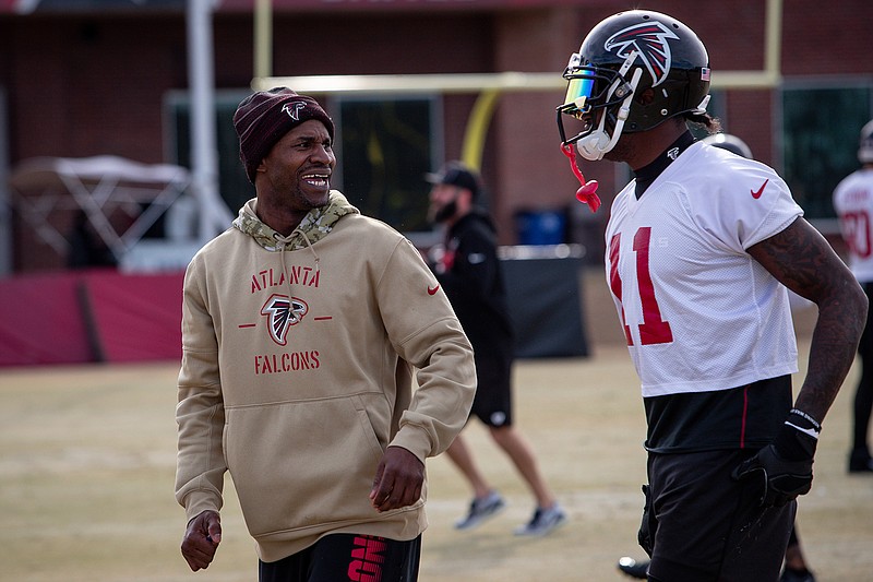 Atlanta Falcons coach Lance Schulters talks to wide receiver Julio Jones, right, during practice. Schulters faced a dilemma when his decade as an NFL player was ending.  Schulters knew he wanted to continue in the game, possibly in coaching. The problem: He was told to basically start from scratch, sort of like a proven chef being told to work the grill at McDonald's.(Kara Durrette/Atlanta Falcons via AP)