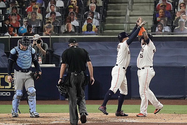 Rays catcher Mike Zunino waits at the plate as George Springer celebrates with Astros teammate Martin Maldonado after hitting a two-run home run during the fifth inning Wednesday night in Game 4 of the American League Championship Series in San Diego.