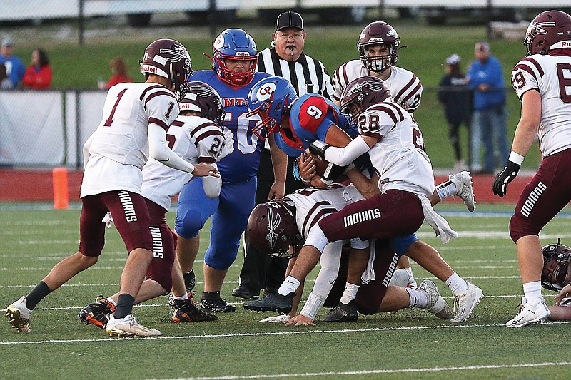 California quarterback Calen Kruger (center) tries to work his way through the School of the Osage defense during a game earlier this season in California.