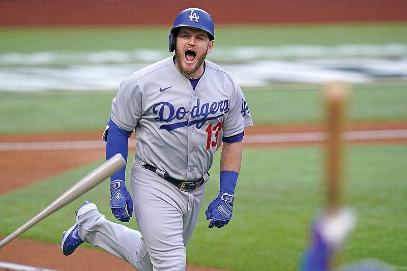 Max Muncy of the Dodgers celebrates his grand slam during the first inning of Game 3 of the NLCS on Wednesday night against the Braves in Arlington, Texas. 