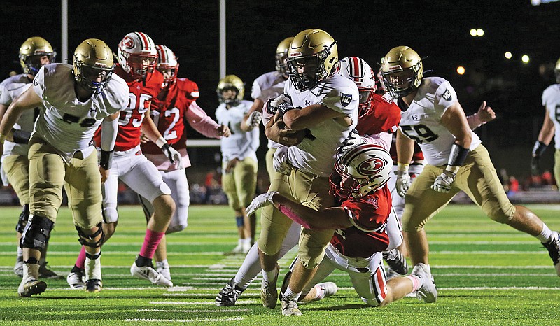 Helias running back Alex Clement runs in for a touchdown as Jefferson City linebacker Will Berendzen wraps him up during last Friday night's game at Adkins Stadium.