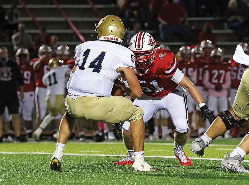 Jefferson City defensive end Josh Copeland closes in on Helias quarterback Jake Weaver during last Friday night's game at Adkins Stadium.