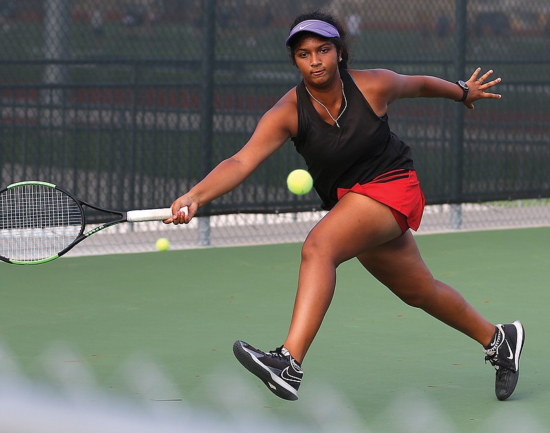 Jefferson City's Sandhiya Baskar leaps forward for a forehand in her singles game against Helias earlier this season at the Crusader Athletic Complex. 