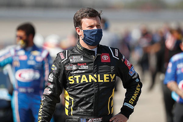 In this Aug. 8 file photo, Erik Jones waits to enter his car before a NASCAR Cup Series race at Michigan International Speedway in Brooklyn, Mich.