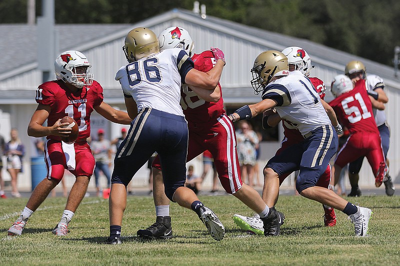 Tipton quarterback Blake Fischer (far left) looks to throw the ball during a game this season against the Helias JV.