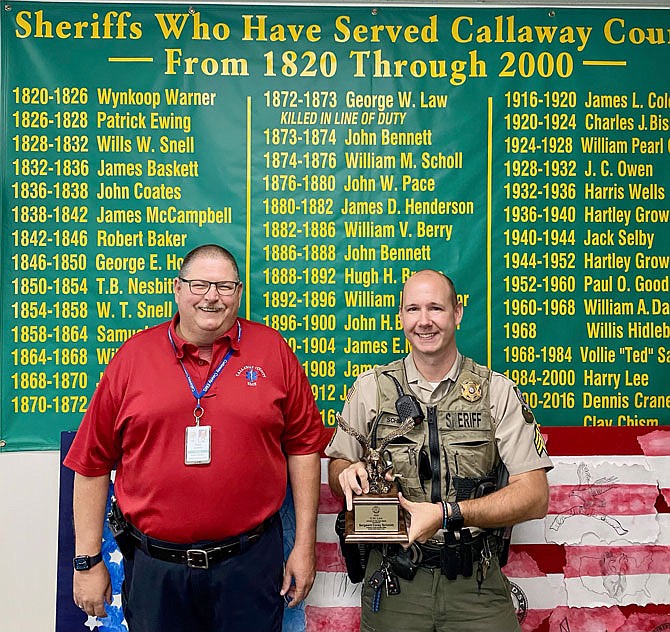 Sgt. Corey Schmidt, right, is the 22nd recipient of the G.W. Law Award, an annual honor given by the Fulton Rotary Club to a law enforcement official who exemplifies Rotary's motto, "service above self." Callaway County Ambulance District Director Charles Anderson presented the award.