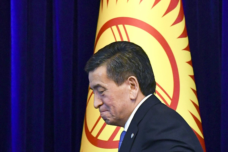 FILE In this file photo taken on Friday, June 14, 2019, Kyrgyzstan's President Sooronbai Jeenbekov leaves a news conference in Bishkek, Kyrgyzstan. The president of Kyrgyzstan announced his resignation in a bid to end the turmoil that has engulfed the Central Asian nation after a disputed parliamentary election. In a statement Thursday, Oct. 15, 2020 released by his office. (AP Photo/Vladimir Voronin, File)
