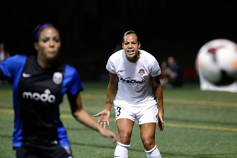In this Aug. 24, 2014, file photo, Washington Spirit's Toni Pressley (3) yells as Seattle Reign FC's Sydney Leroux follows the ball during the first half of a NWSL semifinal soccer match in Seattle. Pressley was looking forward to a comeback season with the Orlando Pride this year after overcoming breast cancer. But then life threw the veteran defender another curve with the coronavirus pandemic and the impact it would ultimately have on the Pride, who were left out of this summer's Challenge Cup tournament. (AP Photo/Elaine Thompson, File)